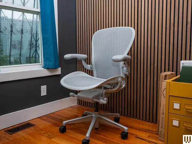 Image may contain: Indoors, Interior Design, Chair, Furniture, Wood Panels, and Office