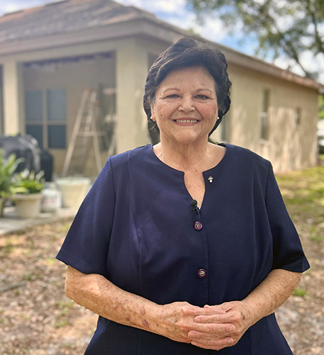 M Cannon poses outside her home